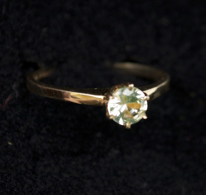 10K Gold Solitaire Ring: Solitaire ring. 10K yg containing one round cut imitation diamond, ring size 8, 1.2dwt.