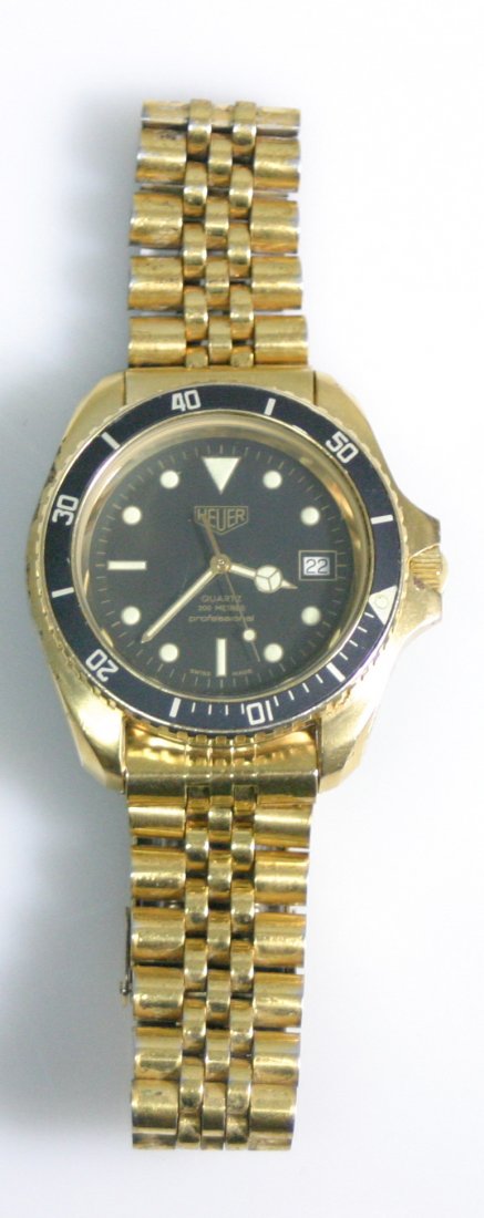 Tag Heuer Series 200 Metre Professional: Acier Etanche diving Watch with light scratching on crystal; gold tone finish is worn on band, case and chipped on the winding crown; overall appears to run well, shows well with black dial and is a l