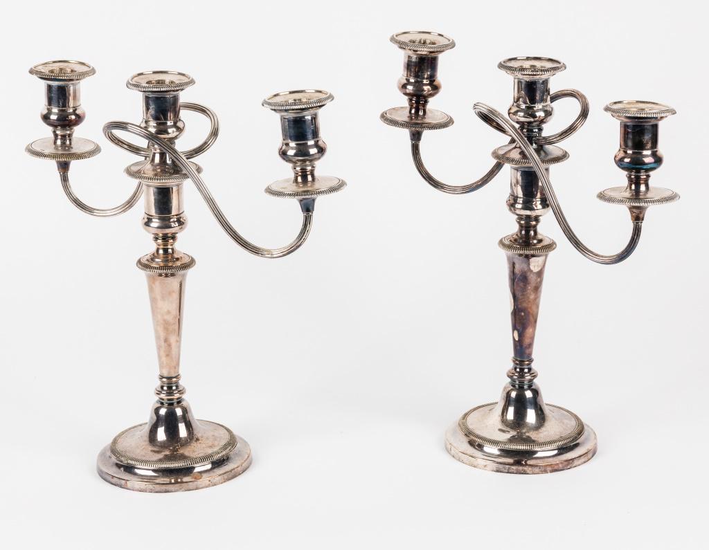 Pair of Electroplated Candelabras: Pair of electroplated candelabras measuring approx. 1 foot high. Condition is as seen in photography.
