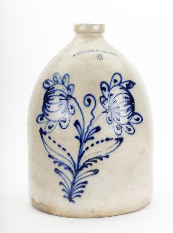 3 Gallon Stoneware Jug w/ Floral Decoration: 3 gallon jug stoneware jug made by N. White & Co., Binghamton. Measures approx. 15.5" high. Good condition with a small hairline crack as seen in photography.