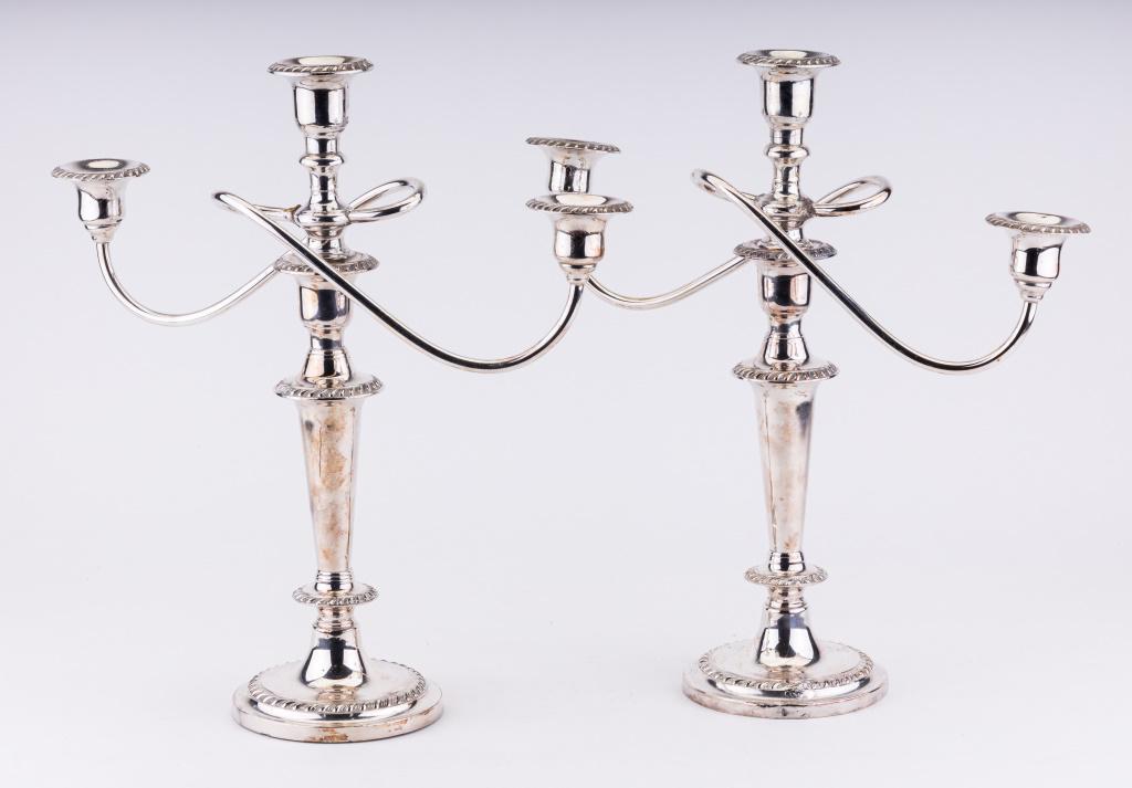 Pair of Silver Plated Candelabras: Pair of candelabras, each with three candle holders and measuring approx 15" tall. The top of the candelabra with the holder is removable to also hold just one candle if needed. The arms on both cande