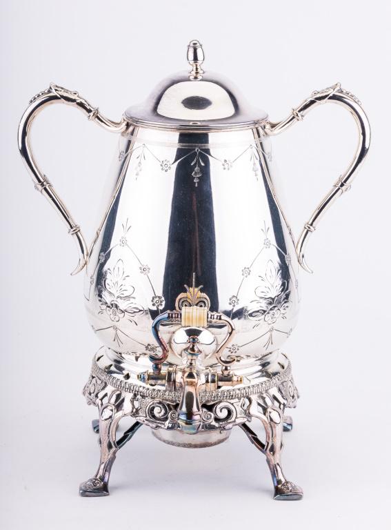 Silver Plated Samovar: Two handled silver plated samovar, measuring approx 13.5" to the lid finial. The bottom is stamped with a hunter holding a bow and arrow. Good condition.