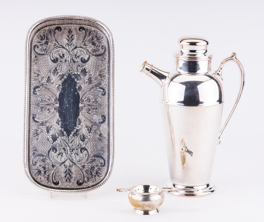 Silver Plated Kitchen & Dresser Items: Silver plated wares including cocktail shaker with "C" monogram and measures approx 11" H; tea strainer; and Reed & Barton Sheffield England dresser tray measuring approx 12" L x 6.25" W.