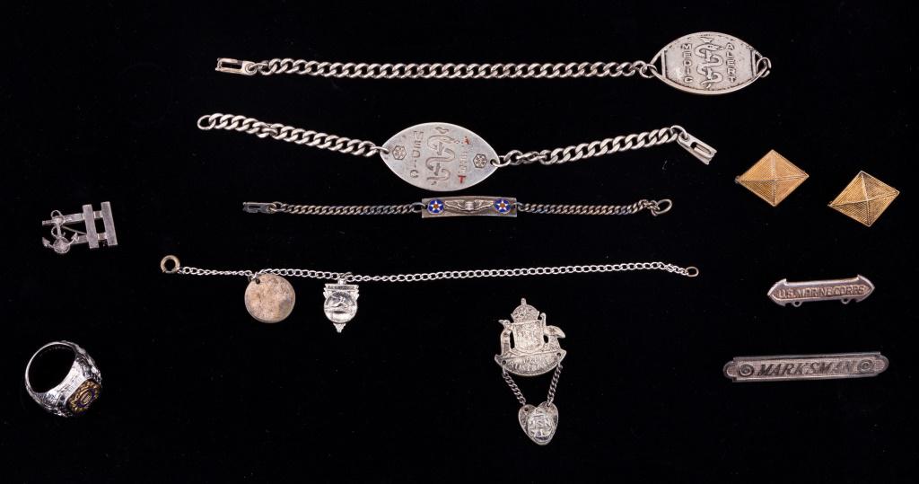 WW2 Sterling Silver Military Jewelry: WW2 sterling silver military jewelry including U.S. Coast Guard ring (size 8.5), anchor pin, Marksman pin, U.S. Marine Corps pin, two diamond shaped pins, 1944 U.S. Navy Australia souvenir, two medica