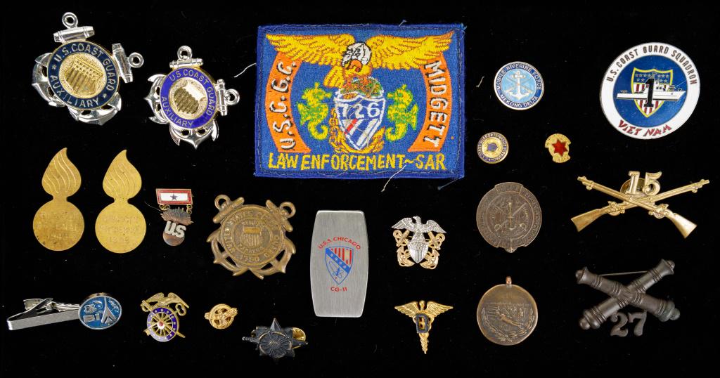 Vintage Coast Guard and Military Insignias & More: 22 piece lot of vintage military insignias, tie bars, a patch, Zippo pen knife and more. There is a WW1 bronze medal.