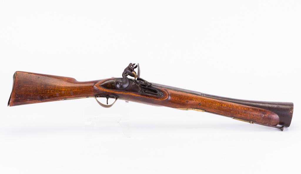 Belgian Flintlock Blunderbuss: A Belgian flintlock Blunderbuss with a barrel diameter of approx. 3 9/16 inches on the end and a barrel length of approx. 17.5". A rounded piece of brass is present opposite the lock, screwed in with 