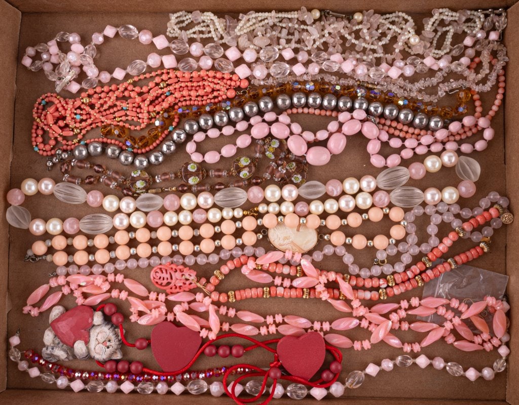 Red & Pink Hue Necklaces: Lot of approx 32 necklaces in red and pink tones including glass, stone, plastic and more. Some have missing findings. See photos.