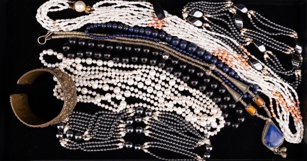 Vintage Jewelry Assemblage: Includes hematite, pearl design, silver tone clasp design bead necklace with lapis, other necklaces and vintage cuff with Egyptian motif.