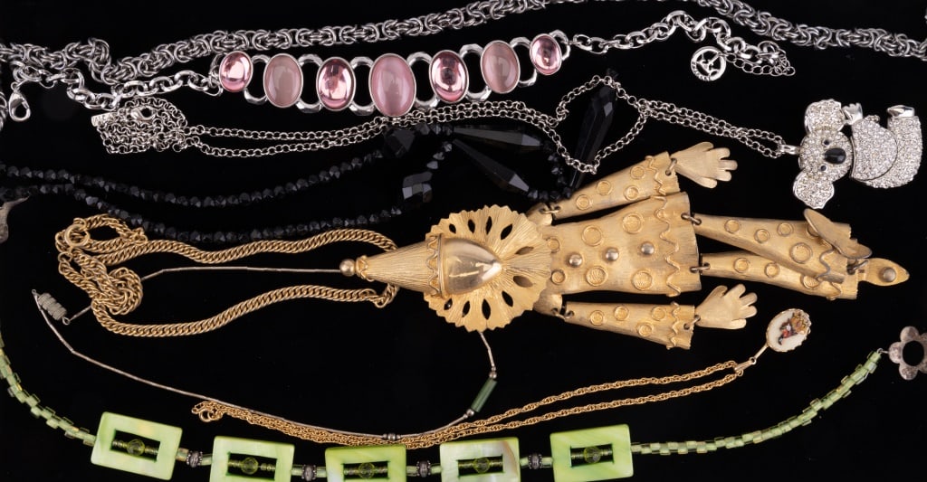 Weiss Large Clown Necklace & Trifari: Lot of 8 necklaces including a large Weiss gold tone necklace with large moveable clown pendant (wearable length approx 18" L and clown pendant approx 8" L) and a Trifari pink cabochon necklace amongs
