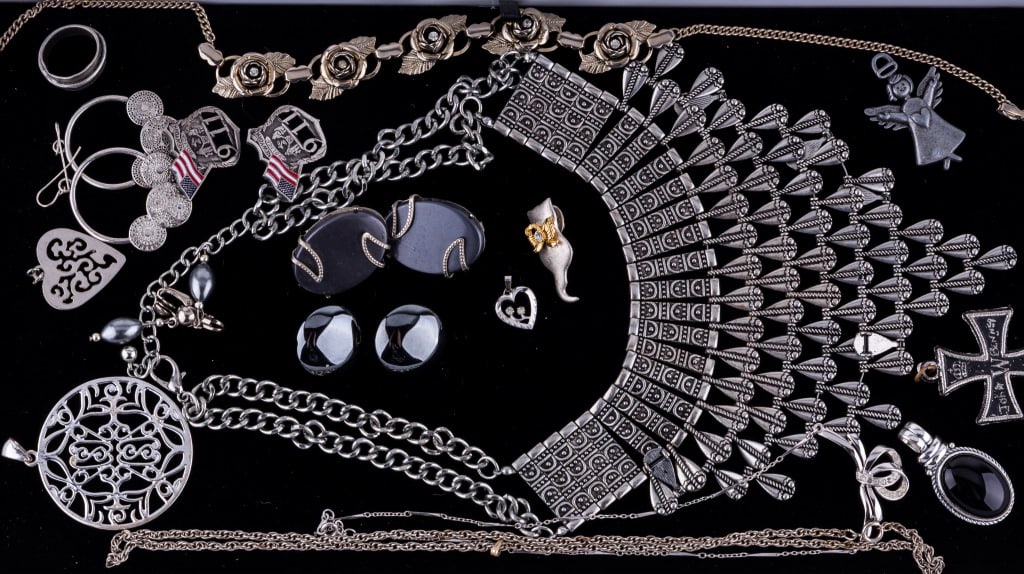 Silver and Silver Tone Costume Jewelry: Silver tone statement neklace measuring approx. 14" long, a silver tone rose choker necklaces along with two other necklaces, four pairs of earrings, six pendants (heart shaped marked sterling), and t