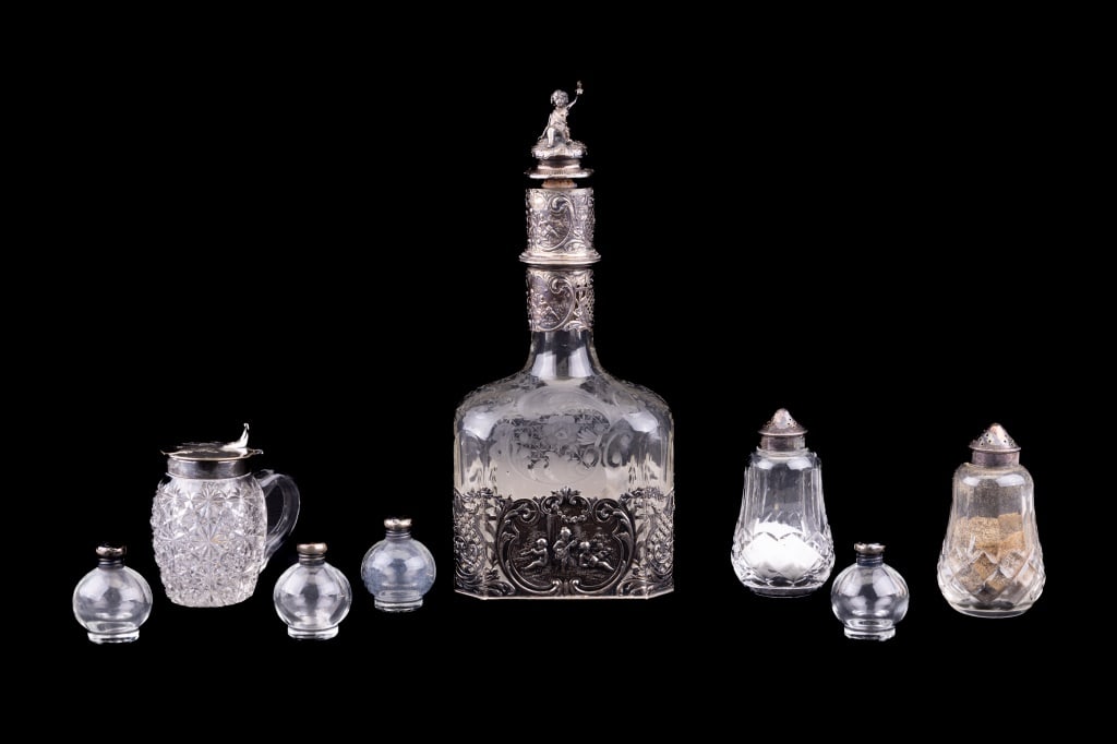 Sterling Glass Decanter & More Dining: Etched glass decanter with intricate sterling wrapped decoration with putti and cherubs in musical theme (approx 11.5" H, has 3 hallmarks). Cut glass honey pot with 3.5" silverplate lid. Two salt and 