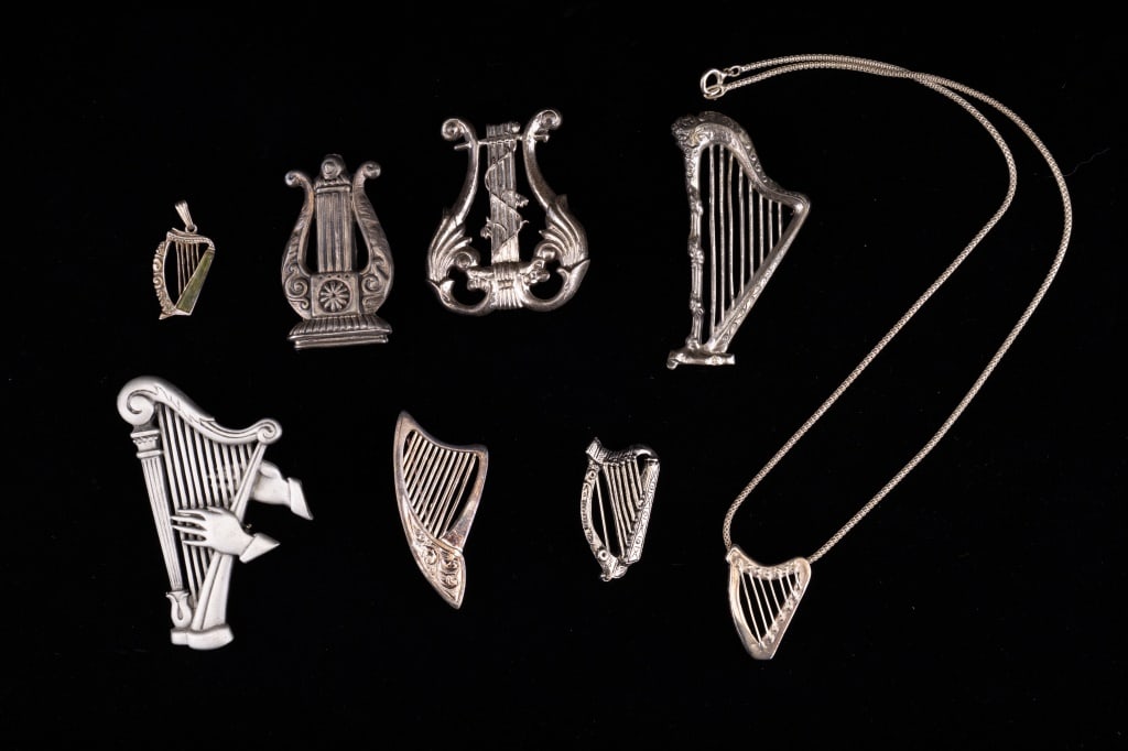 Sterling Silver and More Harp Brooches & Pendants: Sterling silver brooches including Mexico 925, Lang sterling (2), pendant with Conemaugh marble 925. Pendant on chain signed "Lugma", pewter harp with hands signed JJ and two unsigned metal harps.