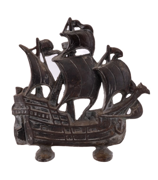 1930 Cast Iron Door Stop, Ship Shape: Decorative cast iron footed door stop ship measuring approx 11.5" H. Dated 1930 on reverse with "Copyright Creation". Has nice patina as seen in photo.