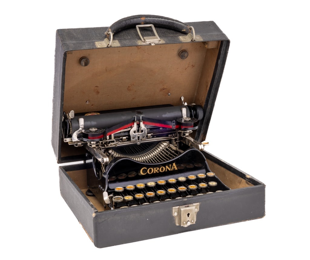 Corona Typewriter in Case: Corona folding and portable antique typewriter that folds away into a case measuring approx 5" H x 11.25" W x 10" D. Possibly No. 3 Corona typewriter. Has not been tested.