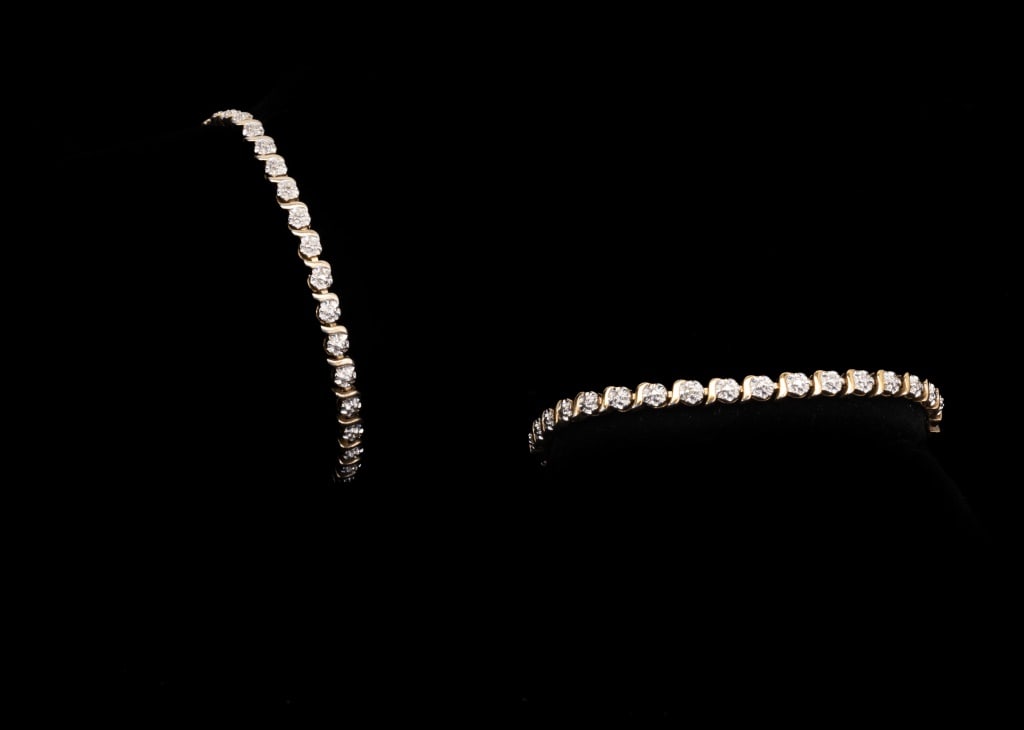 Two Sterling w/ Gold Overlay Tennis Bracelets: Lot is in great condition, marked .925 on both bracelets. Both bracelets approx. 8" long
