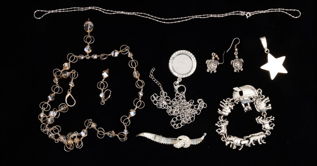 Sterling & Silver Tone Grouping: Sterling silver items include a thin sterling chain, hollow sterling star charm, and sterling necklace and earring set with glass stones. Also includes a Noah's Ark silver tone bracelet, turtle silver