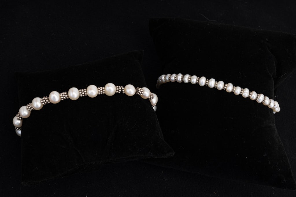 Two Sterling Silver Pearl Bracelets: Two sterling silver and pearl bracelets, one with dolphin charm. Both bracelets measure approx 7" wearable length. Bracelets are in good condition, pearls are genuine.