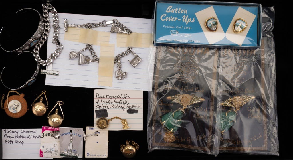 Vintage Gettysburg Souvenir Jewelry & More: Lot of vintage jewelry souvenirs from Civil War Gettysburg, Pennsylvania including 2 charm bracelets and charms, cuff bracelets, pin, button covers, 2 vintage Buddha pins and more.