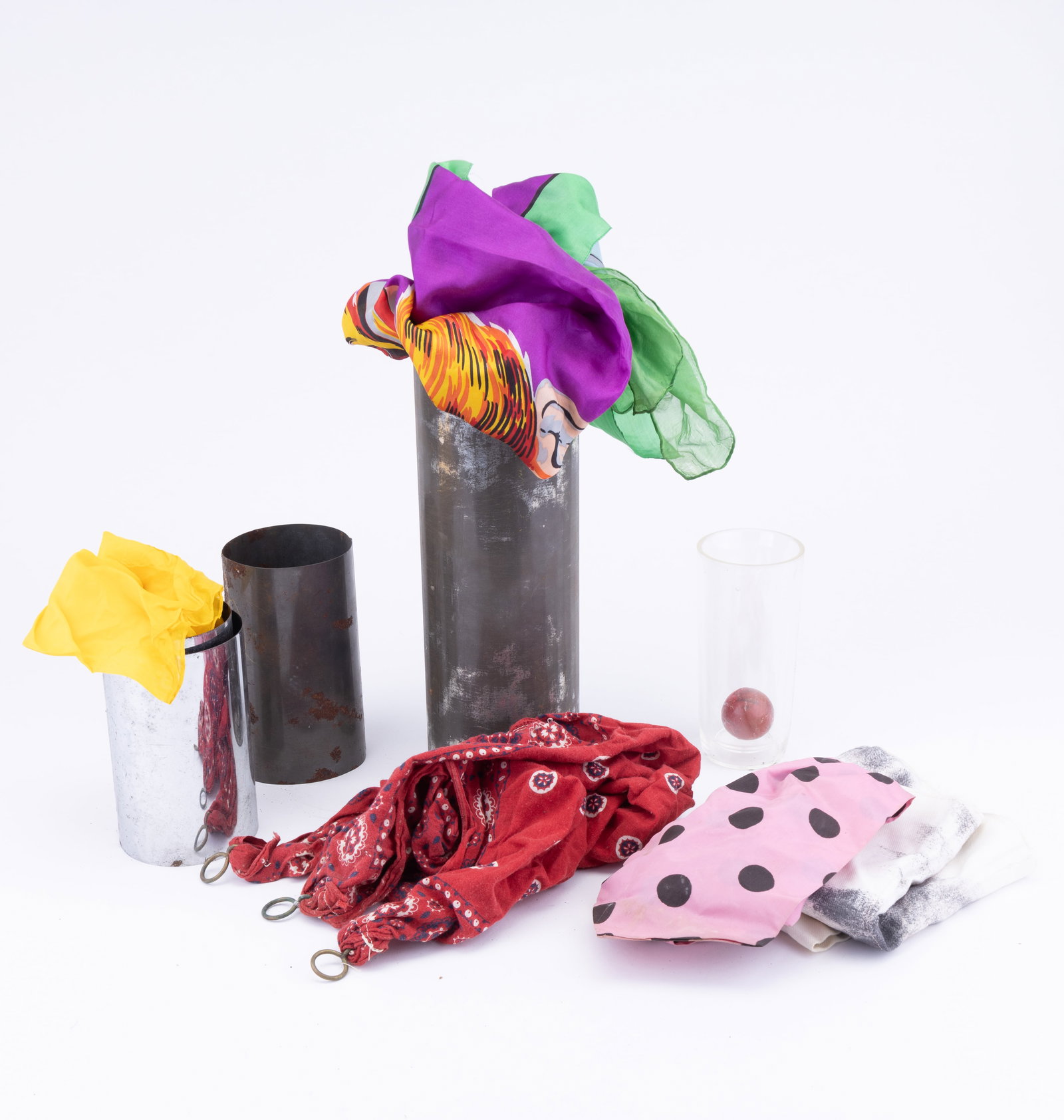 Vintage Magician Trick Silks & More: Collection of vintage magician's silks, nested metal pieces (possibly water tubes), glass with ball and directions for Zenith silk and Water Tubes.