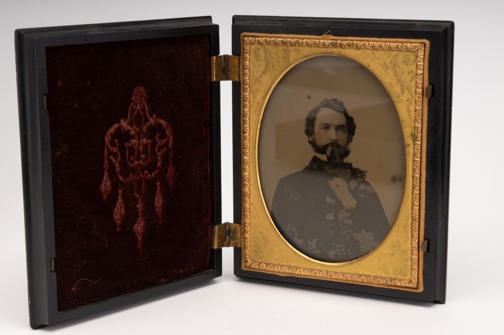 Quarter Plate Ambrotype in Fine Union Case: Fine antique Union case by A.P. Critchlow & Co. holding an ambrotype of a distinguished young gentleman with beard, in gilt brass spandrel. The case depicts George Washington and his horse greeting th