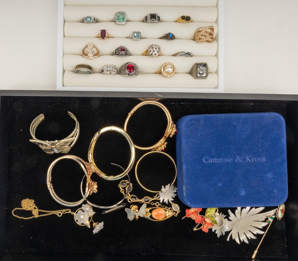 Rings, Bracelets & More Vintage Jewelry: 17 rings including class rings with stones that test in the range of ruby and spinel. There is also a mother of pearl butterfly cuff bracelet, silver tone leaf brooch and earring set, Camrose & Kross 