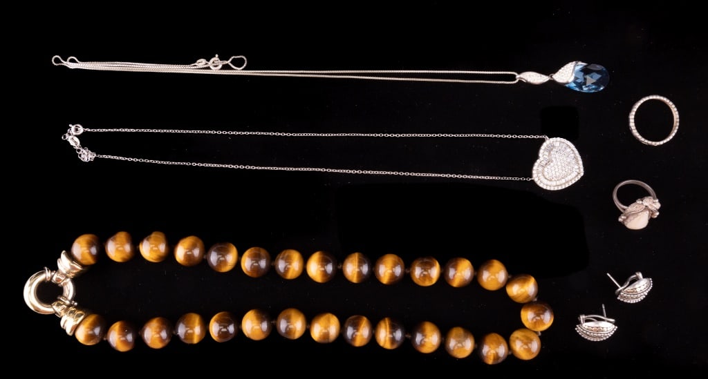 Tiger Eye Necklace & More Sterling Silver Jewelry: Six pieces of sterling silver jewelry including a necklace with real tiger eye beads and gold wash over sterling clasp. Measures approx 15" L. Also includes two more necklaces with glass stones, a pai