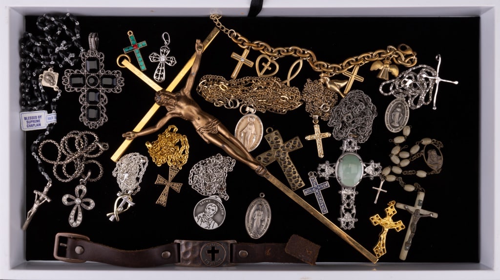 Religious Jewelry (22): 22 items of religious jewelry featuring a charm bracelet, necklaces, pendants, and medallions.