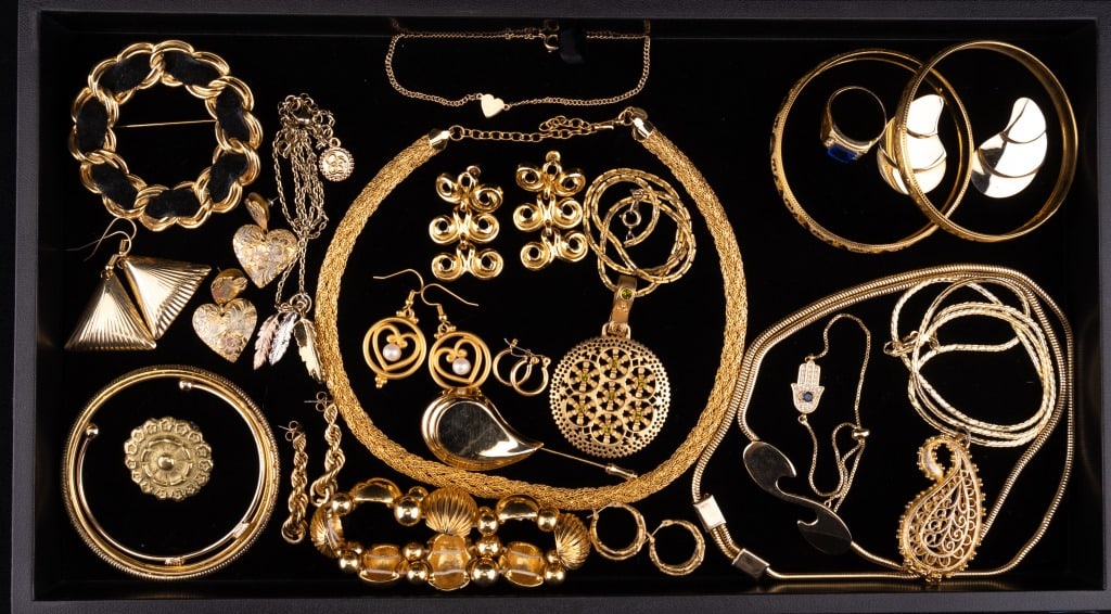 Gold Tone Statement Jewelry: 2 trays with 45 pieces of gold tone statement jewelry including necklaces, bracelets, brooches, earrings, and one ring.