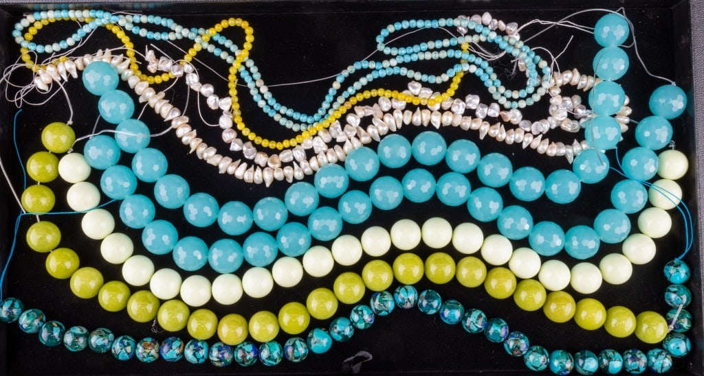 Chalcedony & Other Semi-Precious Strands: Large polished and faceted blue chalcedony strands and several green hued strands.