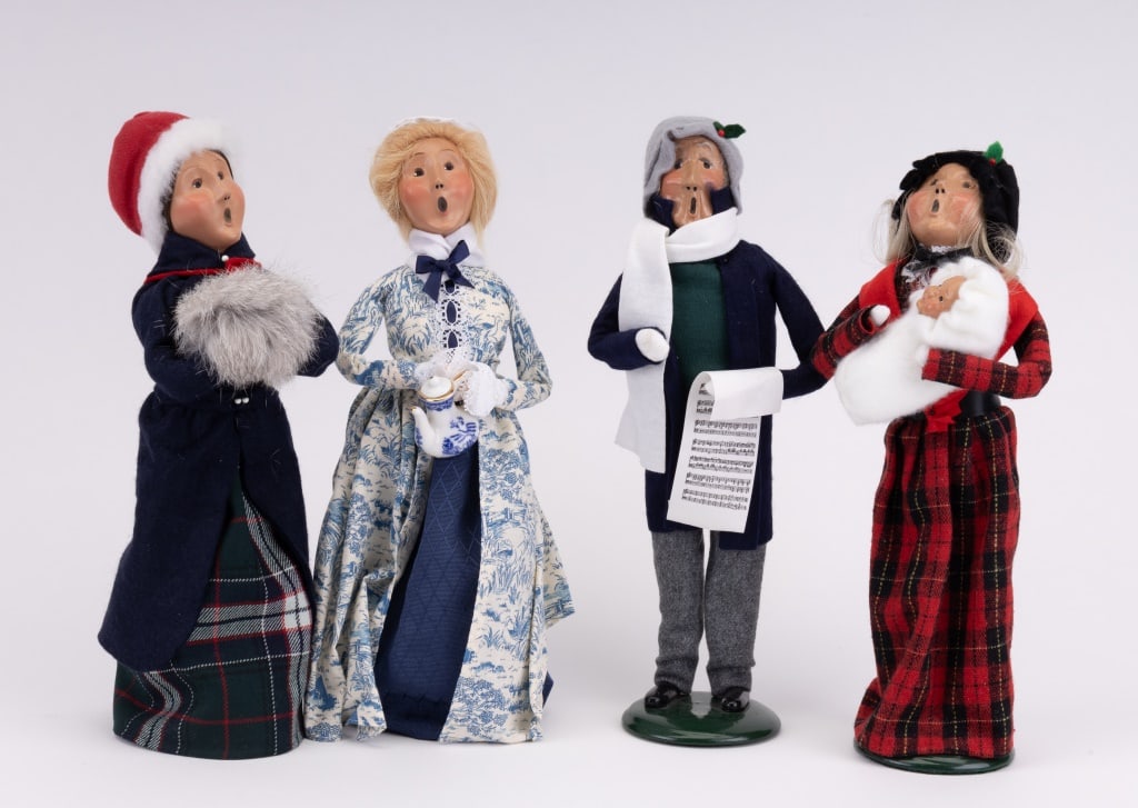 Byer's Choice Carolers Figurines: Collection of 4 Byer's Choice Figurines in original boxes including woman with muff, woman with tea pot, and husband and wife with baby. Figurines measure approximately 13" high. Christmas.