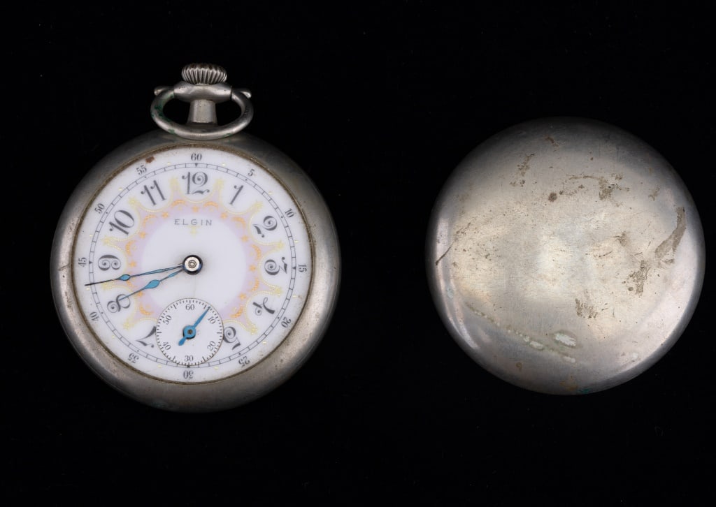 Elgin Pocket Watch Seven Jewels 14157525: Beautiful face marked Elgin with stars and moons in yellow and orange within a pink border inside the ring of numbers. Missing its crystal. The hands are blue and it has a second counter. Back cover s