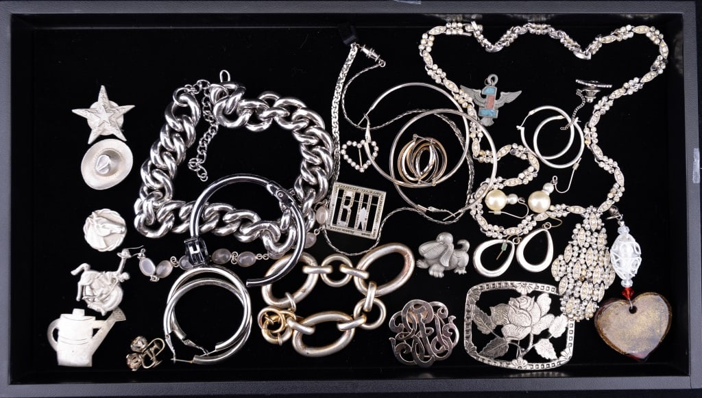 Rhinestone and Costume Jewelry: Lot consists of a Rhinestone necklace missing some stones, Marcasite pendant pin and Fur clip (both also missing some stones), Heavy costume link necklace and similar bracelet, western themed button c