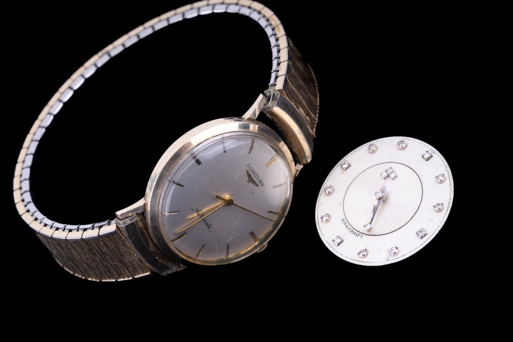 Longines Antique Watch & A Diamond Movement: Longines circa 1950's automatic gold fill watch in working order and Longines diamond hand mystery watch 17 diamond 17 jewel movement. In working to non-working conditions.