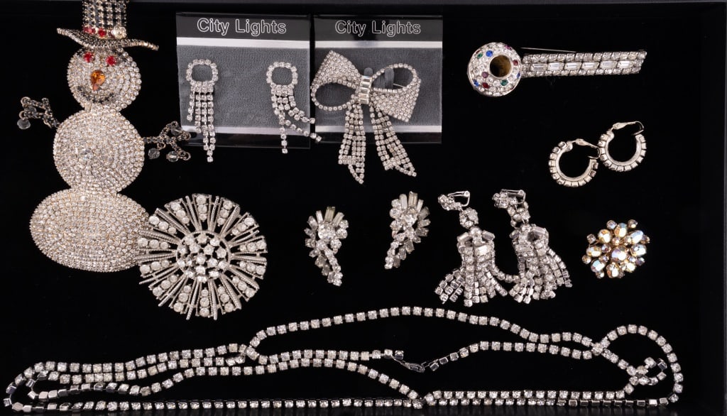 Rhinestone Costume Jewelry: 11 pieces of rhinestone jewelry including a large snowman (approx 5.5" L), four pairs of earrings, four brooches, necklace and large bead.