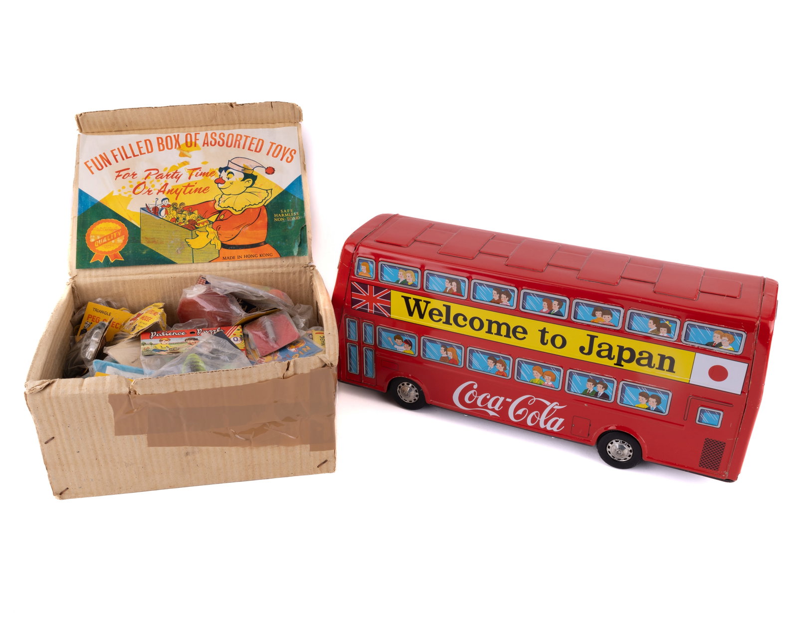 Japanese Tin Litho Bus & Hong Kong Toy Grab Box: Includes Japanese tin litho double decker "Welcome to Japan" bus with Coca Cola advertisement on the side, measuring 17.5" L x 7.25" H. Also includes Hong Kong box full of toys for the American market