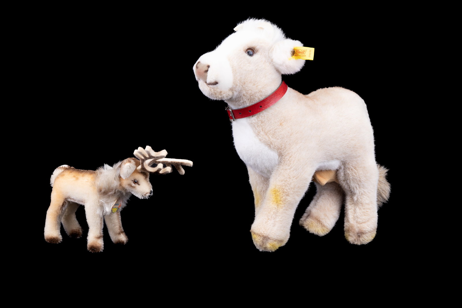 Steiff Mohair Cow & Reindeer Plushie: Two mohair Steiff animals including a cow (approx 12") and reindeer (approx 6"). The reindeer (named Remmy) has original tag and both have ear tags.