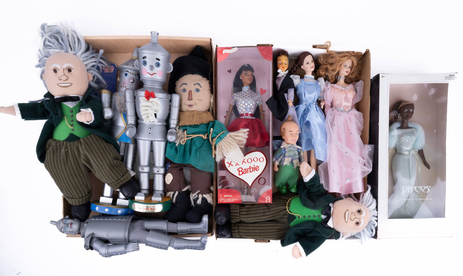 Wizard of Oz, Barbies, Nutcrackers & More: Four groups of Wizard of Oz themed action figures, nutcrackers, Barbies.