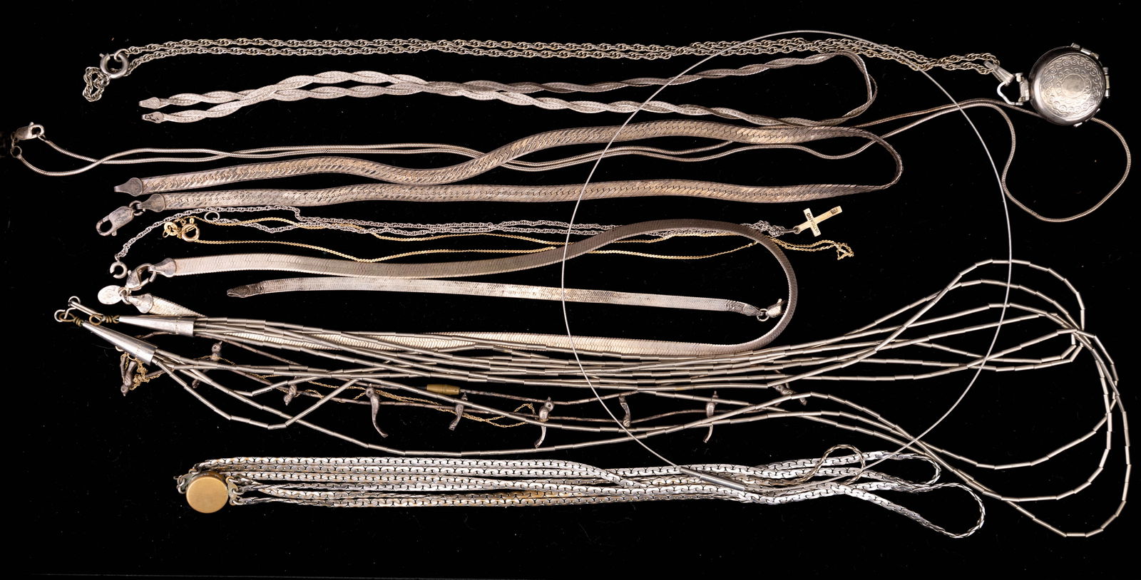 Sterling Silver & Silver Tone Necklaces: 5 sterling silver necklaces, two Native American style (unmarked), a pocket watch, (unopened), and silver tone jewelry.