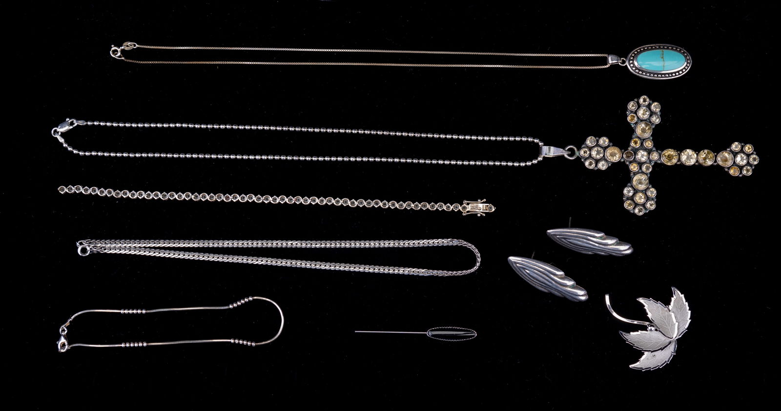 Sterling Silver Necklaces, Earrings, Brooch & More: Eight sterling silver items including three necklaces, anklet, pair of earrings, stick pin and brooch. Necklaces include an approx 17" L chain holding large cross with approx 4" L drop and adorned wit