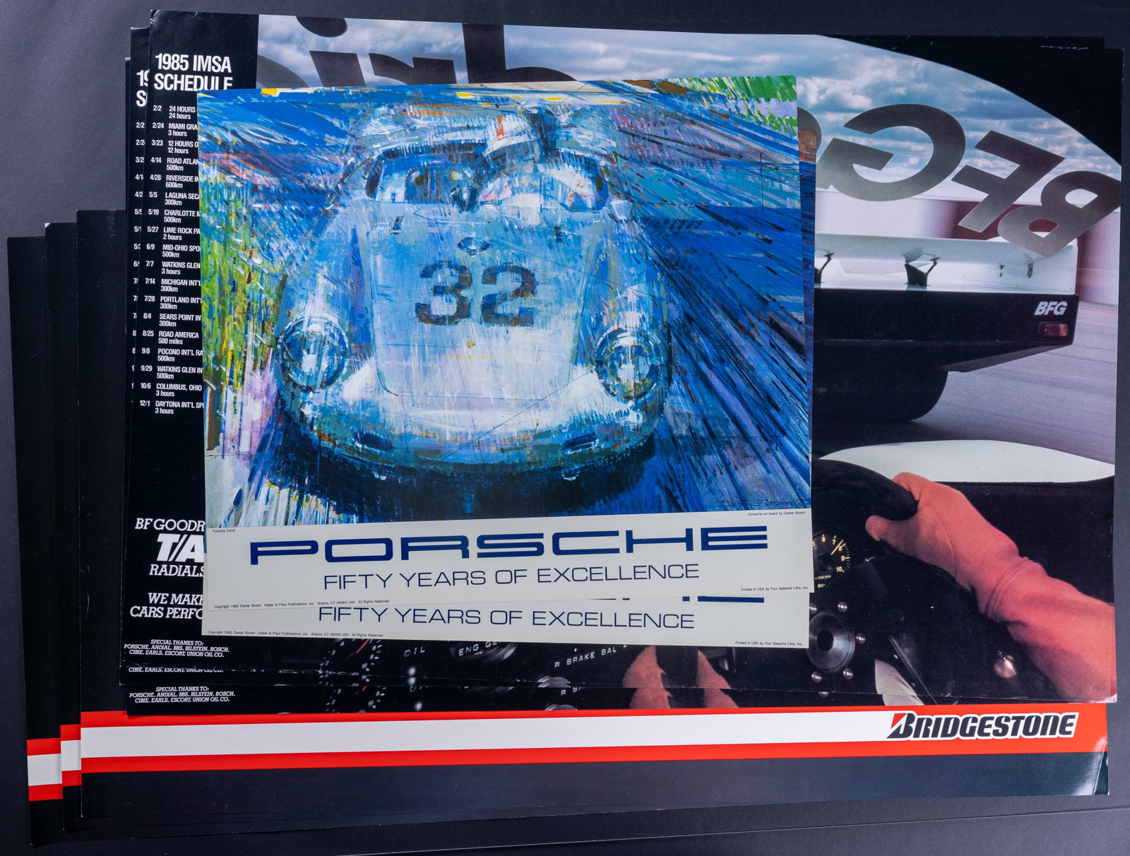 1980s Vintage Porsche Tire Posters (10): 10 Porsche posters including (2) circa 1982 (approx 19" x 22"), (3) Bridgestone Tires (approx 22" x 37"), (5) BF Goodrich 1985 (approx 24" x 36"). A few posters have minor edge wear, one has corner do