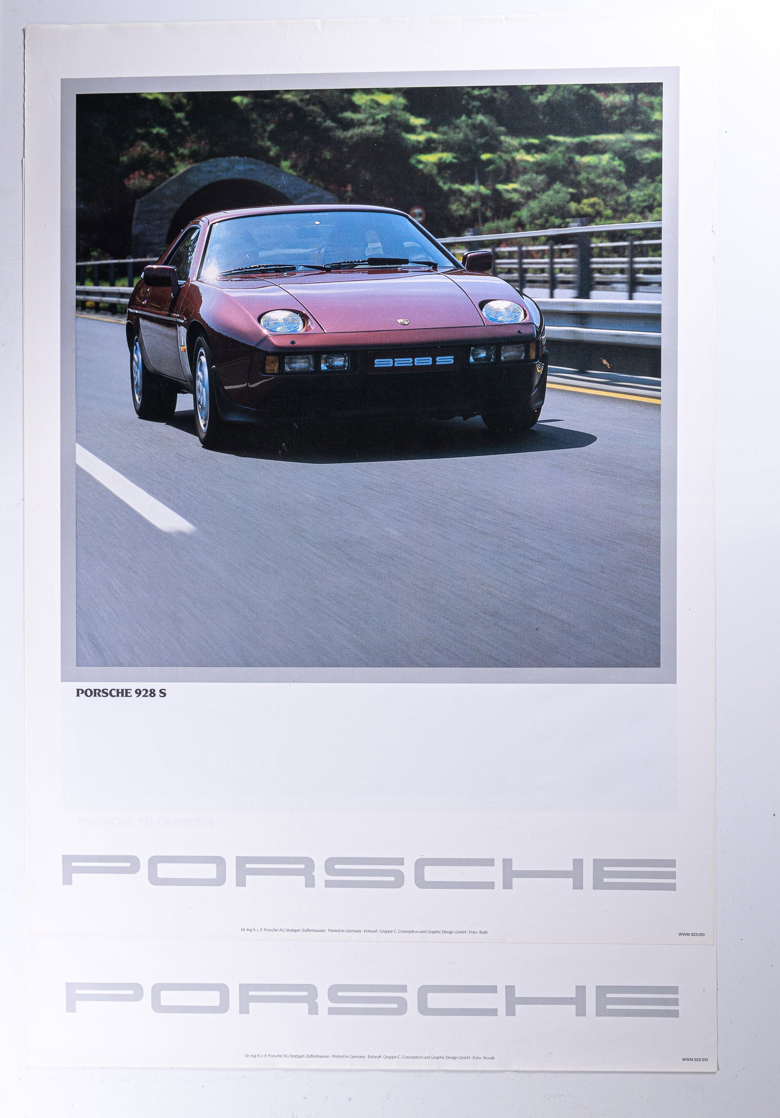 1980s Porsche 911 & 928 S Advertisement Posters: Two posters including Porsche 911 Carerra and Porsche 928 S original advertising posters with minor edge wear and corner bends. Not dated. Measures approx 30" x 40".