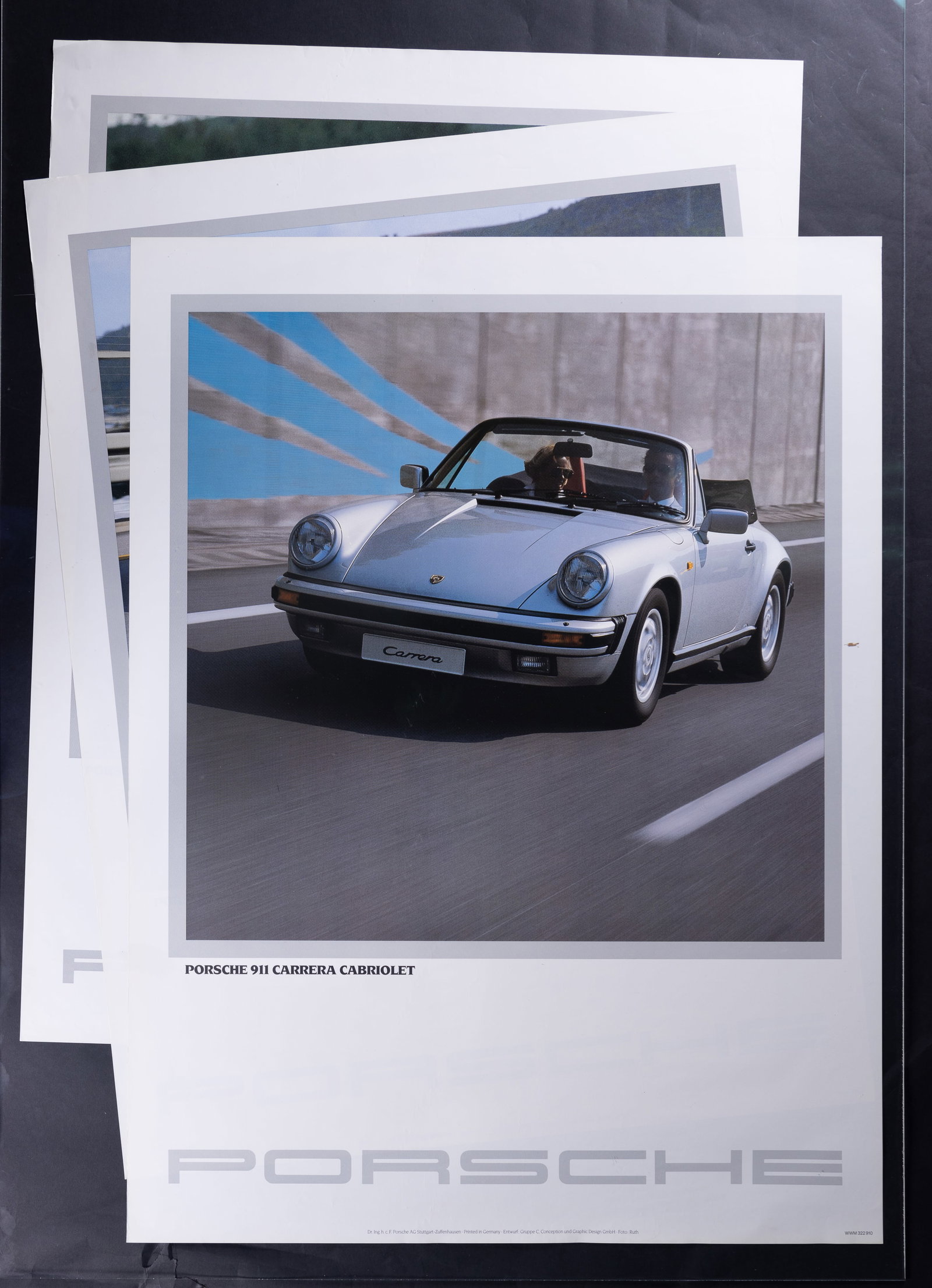 1980s Porsche 911, 944, 924 Advertisement Posters: Three Porsche 911 Carrera Cabriolet, Porsche 944 and Porsche 924 original advertising posters, each measuring approx 30" x 40". One folded corned on each poster and minor edge wear.