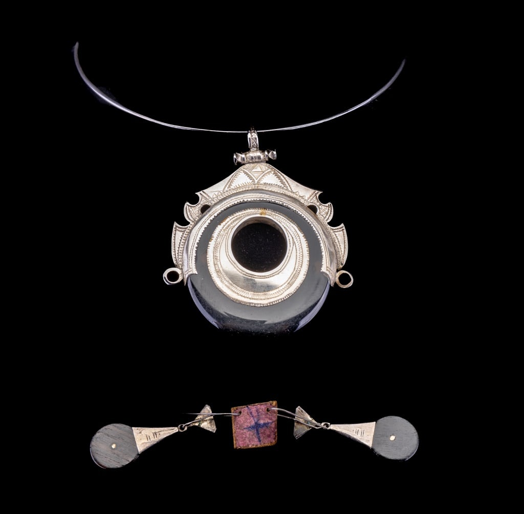 Silver Choker with Pendant and Earrings: Choker disk (approx 5" dia) has a highly decorated silver and polished black mineral pendant; the pendant is hallmarked on back with cross hatch and measures approx. 3"H x 2.75"W. It is accompanied by