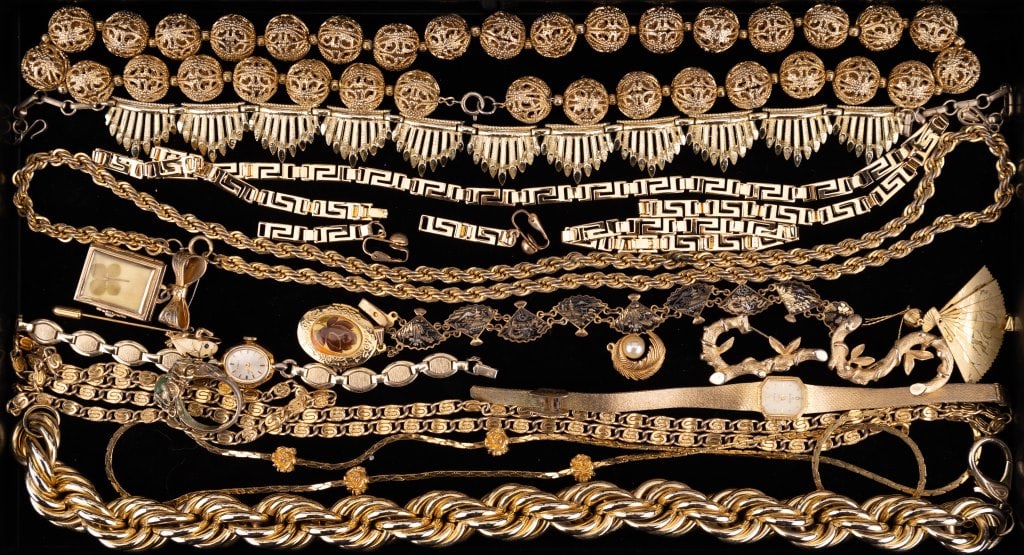 Siam, Coro & More Gold Tone Jewelry: Variety of gold tone necklaces and more jewelry including Coro book style locket with clover, Siam fan bracelet (marked Japan) and pendant, 18K GF brutalism style ring (size 10, has verdigris) and mor