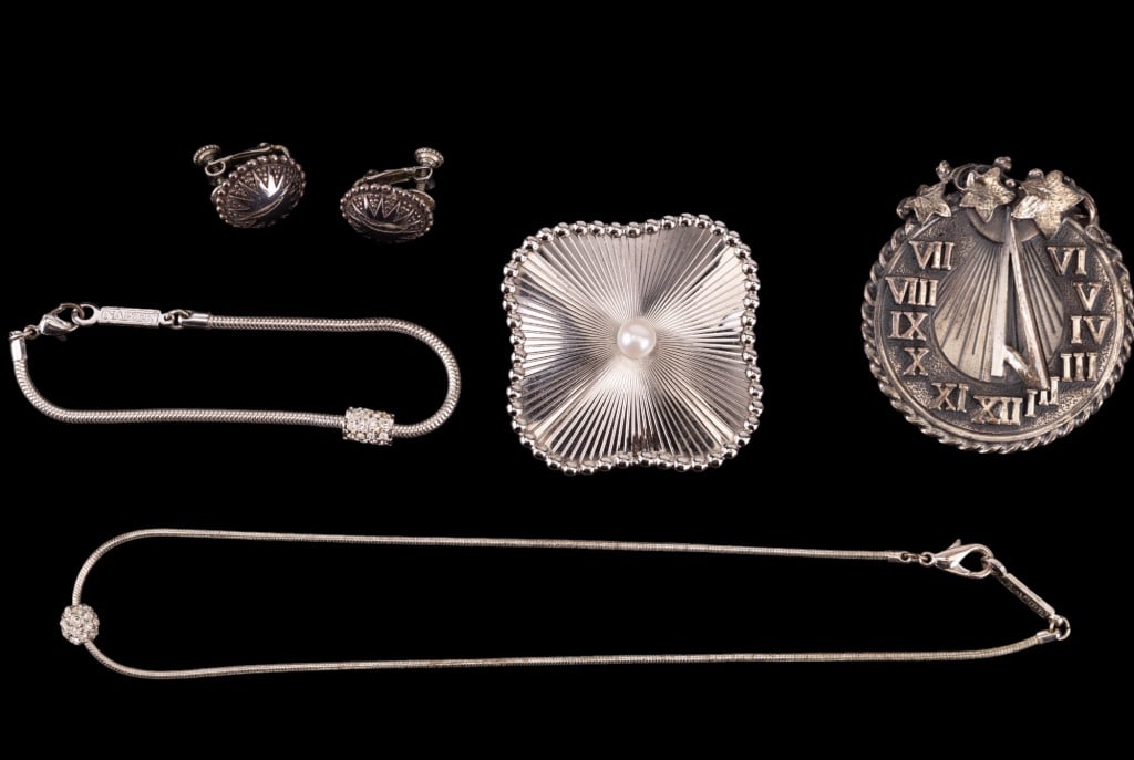 Napier Silver Tone Vintage Jewelry: Five pieces of silver tone vintage Napier jewelry including matching necklace and bracelet set, sun dial brooch (approx 2" dia), another brooch with central faux pearl and a pair of screw back earring