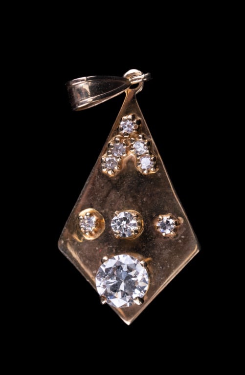 14K Gold Diamond Pendant: 14K gold (marked 585) pendant with 9 diamonds. The largest diamond measures approx 4.73mm (approx 0.25 carats). Pendant drop approx 1 1/4" L x 0.5" W and weighs approx 2.7g.
