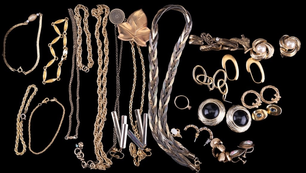 Gold Tone Costume Jewelry: Gold tone jewelry lot including earrings, necklaces, dangle bracelets and more. One bracelet is marked Monet.