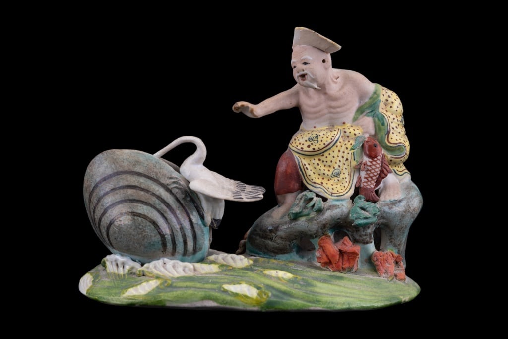 Chinese Porcelain Elder with Stork & Clam: Intricately detailed Chinese porcelain statue of elder, stork, and clam. Marked on bottom. Approximate measurements 4" H x 5 1/2" W 3" D. Piece of elder's hat is missing.