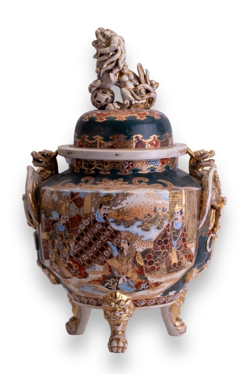 Japanese Porcelain Incense Burner: Large Japanese porcelain lidded and footed incense burner. The burner measures approx 18" H x 14 W with handles. Depicts dragon handles and finial is a foo dog.