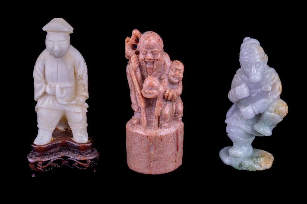 Jadeite & Other Carved Figures: 3 carved Chinese figures including jadeite dancing figure with open hands to hold incense stick or similar, soapstone chop seal with scholar figure and probable alabaster scholar figure on wooden stan